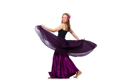 A woman in purple dress holding up her skirt